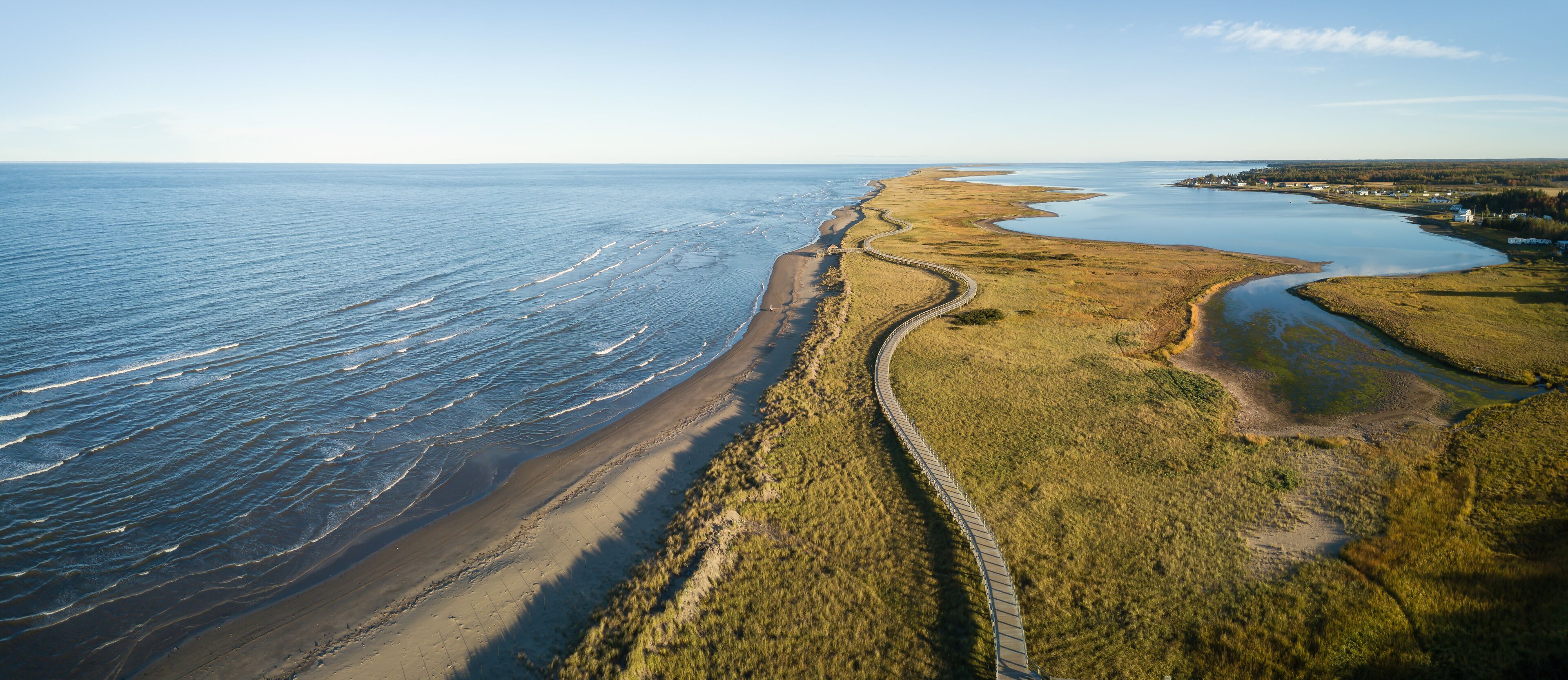 Aerial panoramic view of a beautiful sandy beach on the Atlantic Ocean Coast. Taken in La Dune de Bouctouche, New Brunswick, Canada.