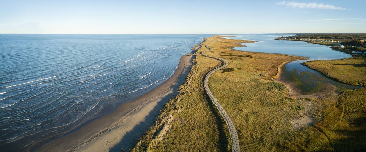 Aerial panoramic view of a beautiful sandy beach on the Atlantic Ocean Coast. Taken in La Dune de Bouctouche, New Brunswick, Canada.