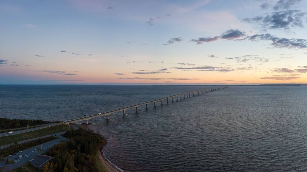 Aerial Panoramic view of Confederation Bridge to Prince Edward Island during a vibrant sunny sunrise. Taken in Cape Jourimain National Wildlife Area, New Brunswick, Canada.
