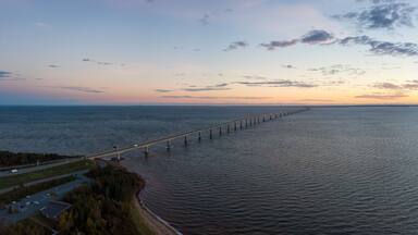 Aerial Panoramic view of Confederation Bridge to Prince Edward Island during a vibrant sunny sunrise. Taken in Cape Jourimain National Wildlife Area, New Brunswick, Canada.