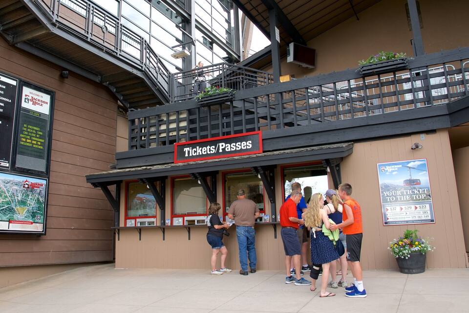 A ticket booth with a sign reading "Tickets/Passes" and a sign above it that says "Welcome to Jackson Hole".