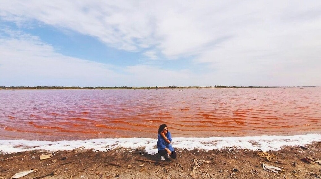 Lac Rose or Lake Retba, the pink lake of Senegal. The pink water is because of the Dunaliella salina algae. The lake has a high salt content and the locals wade into its deep waters to harvest the salt manually #lake #lakeretba #senegal #lacrose #wondersoftheworld
