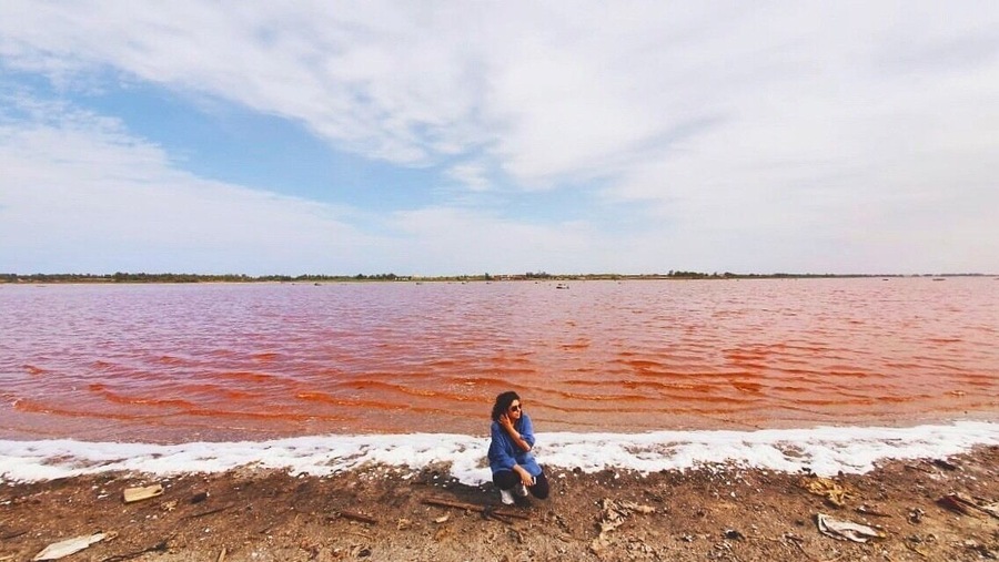 Lac Rose or Lake Retba, the pink lake of Senegal. The pink water is because of the Dunaliella salina algae. The lake has a high salt content and the locals wade into its deep waters to harvest the salt manually #lake #lakeretba #senegal #lacrose #wondersoftheworld