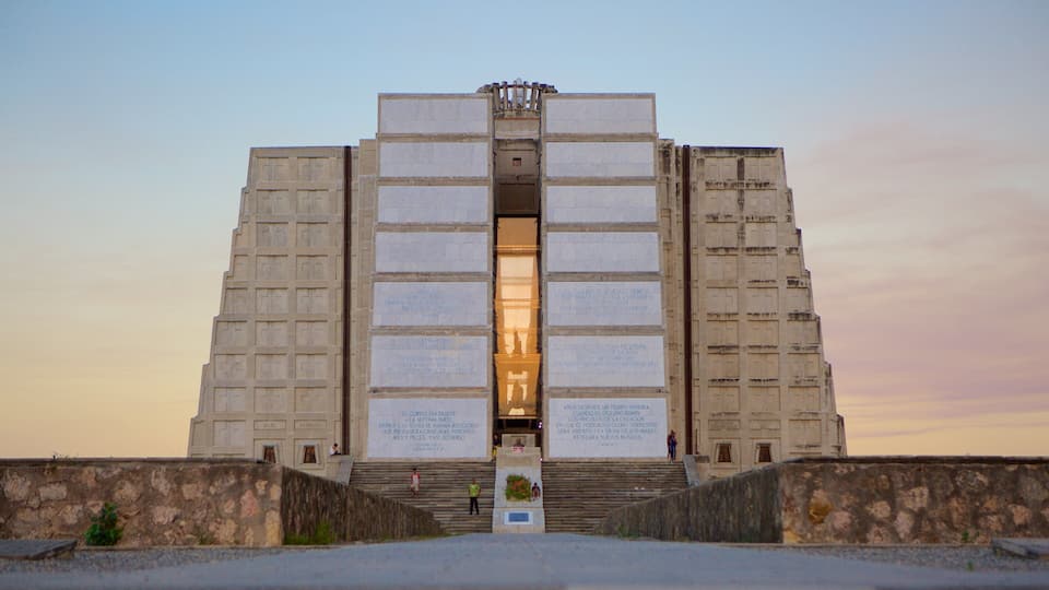 A large, symmetrical building with a central entrance and multiple plaques on its facade.