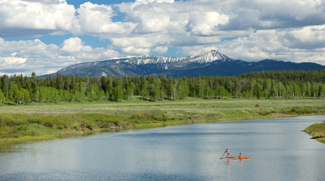 Oxbow Bend featuring kayaking or canoeing, tranquil scenes and mountains