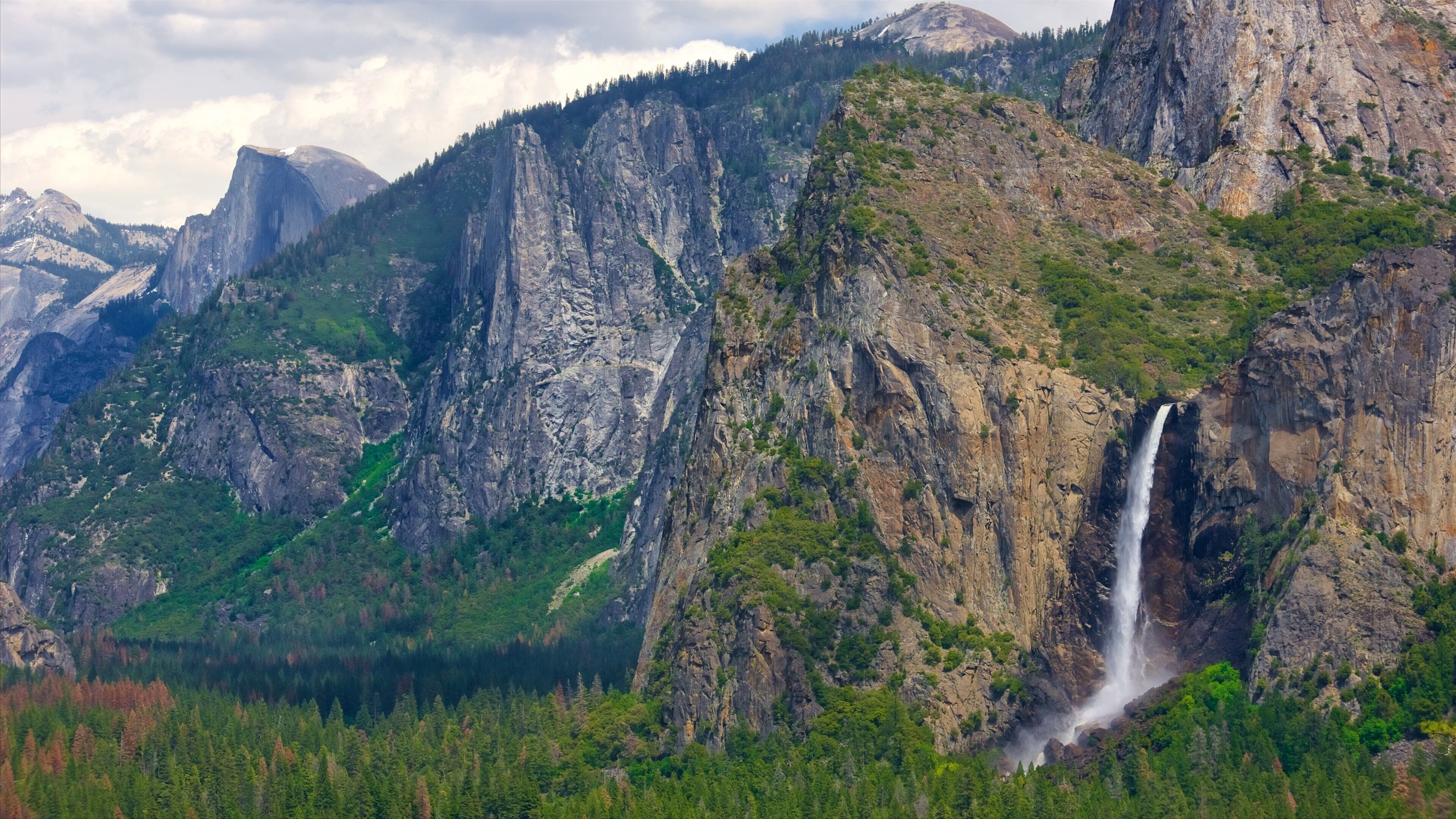 Tunnel View featuring mountains, forests and a waterfall