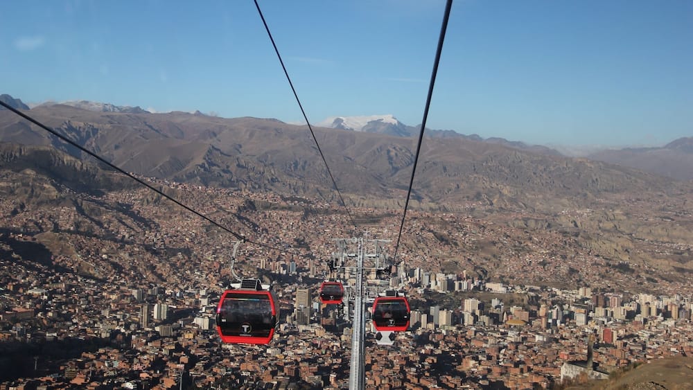 The cable car, opened on 30th May 2014, connects La Paz to the sprawling Metropolis of El Alto high above the city.
Teleférico was inaugurated by Bolivia's current president, Evan Morales, in order to improve the commute to La Paz for residents of El Alto. Although only 11 kilometres as the crow flies, by road this is a long, arduous journey which can take well over an hour.
Although built for the purpose of the city's commuters, it's also great news for visitors. A ride on the cable car (which will set you back 3 bolivianos for a one-way ticket) affords some stunning views of La Paz, and can transport you up to El Alto in around 10 minutes.
El Alto is where the poorer residents of La Paz live, and for that reason it can be unsafe to wander around here without a guide (even with a guide, keep your valuables close to your chest). Red Cap Walking Tours run an extended city tour, which incorporates El Alto, as well as other city attractions not covered on their standard free walking tour.