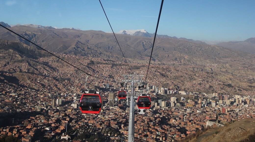 The cable car, opened on 30th May 2014, connects La Paz to the sprawling Metropolis of El Alto high above the city.
Telefรฉrico was inaugurated by Bolivia's current president, Evan Morales, in order to improve the commute to La Paz for residents of El Alto. Although only 11 kilometres as the crow flies, by road this is a long, arduous journey which can take well over an hour.
Although built for the purpose of the city's commuters, it's also great news for visitors. A ride on the cable car (which will set you back 3 bolivianos for a one-way ticket) affords some stunning views of La Paz, and can transport you up to El Alto in around 10 minutes.
El Alto is where the poorer residents of La Paz live, and for that reason it can be unsafe to wander around here without a guide (even with a guide, keep your valuables close to your chest). Red Cap Walking Tours run an extended city tour, which incorporates El Alto, as well as other city attractions not covered on their standard free walking tour.