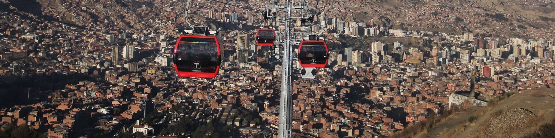 The cable car, opened on 30th May 2014, connects La Paz to the sprawling Metropolis of El Alto high above the city.
Teleférico was inaugurated by Bolivia's current president, Evan Morales, in order to improve the commute to La Paz for residents of El Alto. Although only 11 kilometres as the crow flies, by road this is a long, arduous journey which can take well over an hour.
Although built for the purpose of the city's commuters, it's also great news for visitors. A ride on the cable car (which will set you back 3 bolivianos for a one-way ticket) affords some stunning views of La Paz, and can transport you up to El Alto in around 10 minutes.
El Alto is where the poorer residents of La Paz live, and for that reason it can be unsafe to wander around here without a guide (even with a guide, keep your valuables close to your chest). Red Cap Walking Tours run an extended city tour, which incorporates El Alto, as well as other city attractions not covered on their standard free walking tour.