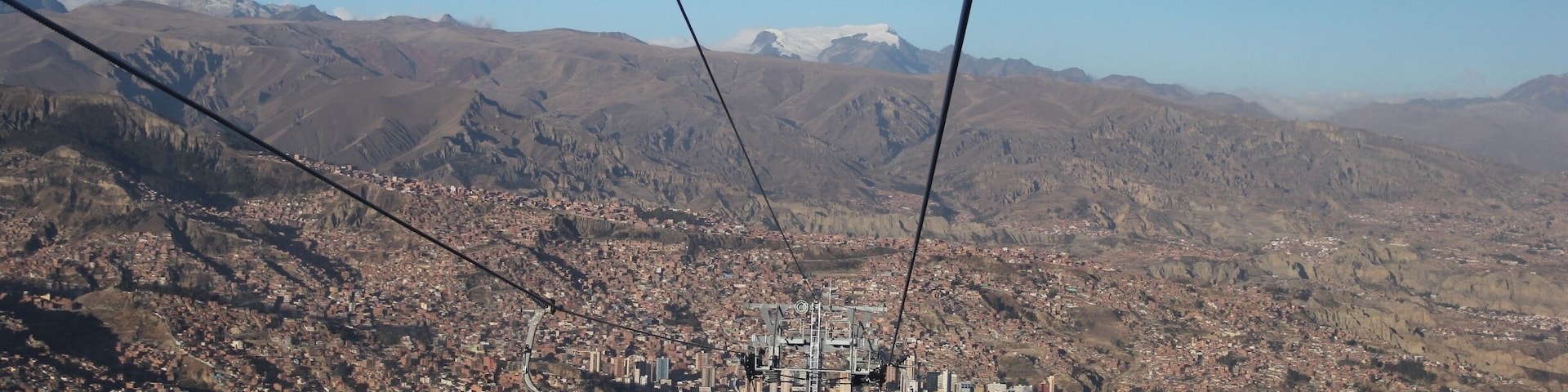 The cable car, opened on 30th May 2014, connects La Paz to the sprawling Metropolis of El Alto high above the city.  
Teleférico was inaugurated by Bolivia's current president, Evan Morales, in order to improve the commute to La Paz for residents of El Alto.  Although only 11 kilometres as the crow flies, by road this is a long, arduous journey which can take well over an hour.
Although built for the purpose of the city's commuters, it's also great news for visitors.  A ride on the cable car (which will set you back 3 bolivianos for a one-way ticket) affords some stunning views of La Paz, and can transport you up to El Alto in around 10 minutes.
El Alto is where the poorer residents of La Paz live, and for that reason it can be unsafe to wander around here without a guide (even with a guide, keep your valuables close to your chest).  Red Cap Walking Tours run an extended city tour, which incorporates El Alto, as well as other city attractions not covered on their standard free walking tour.