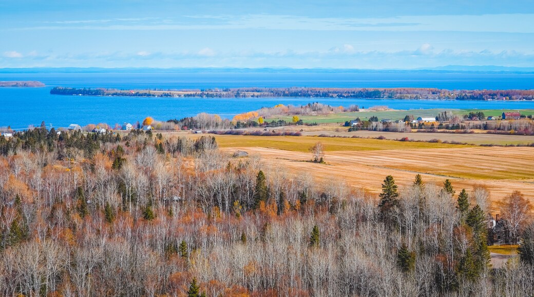 Chambord Skyline with Saint Jean Lake and Fall Foliage against Blue Sky and Clouds in Autumn Sunny Day