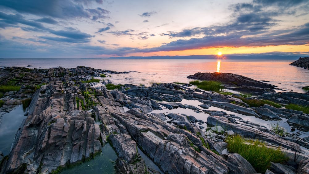 Wonderful sunset at St-Jean-Port-Joli's coasts, at low tide, on the shore of St-Lawrence river.