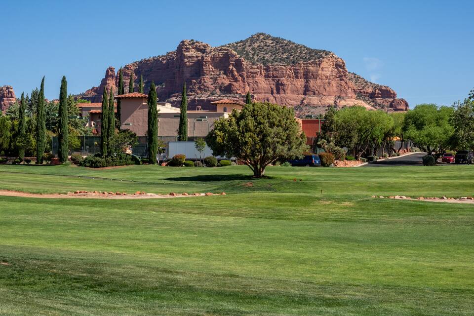 A golf course with a mountain in the background.
