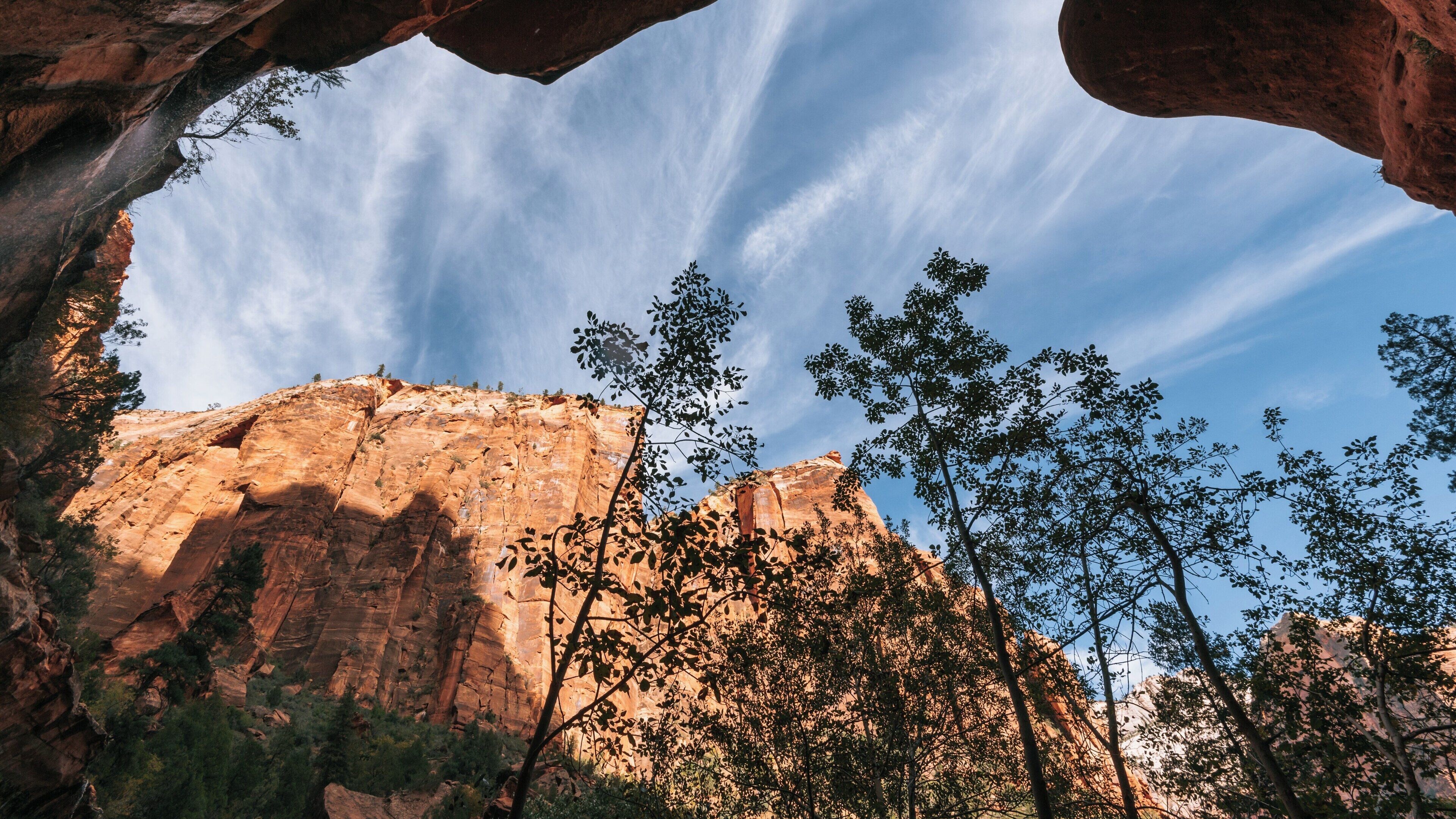 Explore the stunning Emerald Pools at Zion National Park in Springdale, Utah during a clear day with impressive rock formations and blue skies