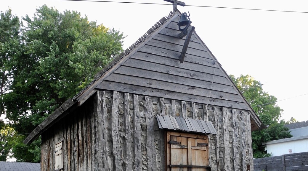 "The first St. Charles Borromeo Church, like this one, was constructed of vertical, hewn logs placed directly in the ground: an architectural style unique to the French in the New World during the 17th and 18th centuries. The church has been rebuilt on its original location. Jesse Francis, a local preservationist with 20 years experience restoring 18th French log buildings, directed the reconstruction. The work was done completely by with period tools in the manner of the 18th century. The church is part of an on-going historical interpretive program based on a re-creation of daily activities in this old French village."