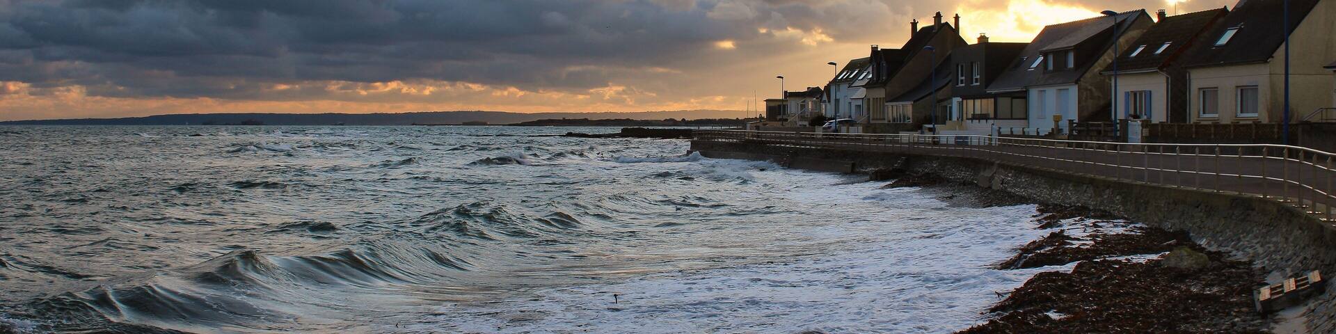 Scenic view of waves on the coastal village of Urville-Nacqueville in France during sunset