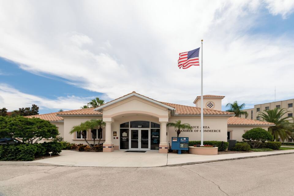 A building with a sign reading "National Center of Commerce" and an American flag.