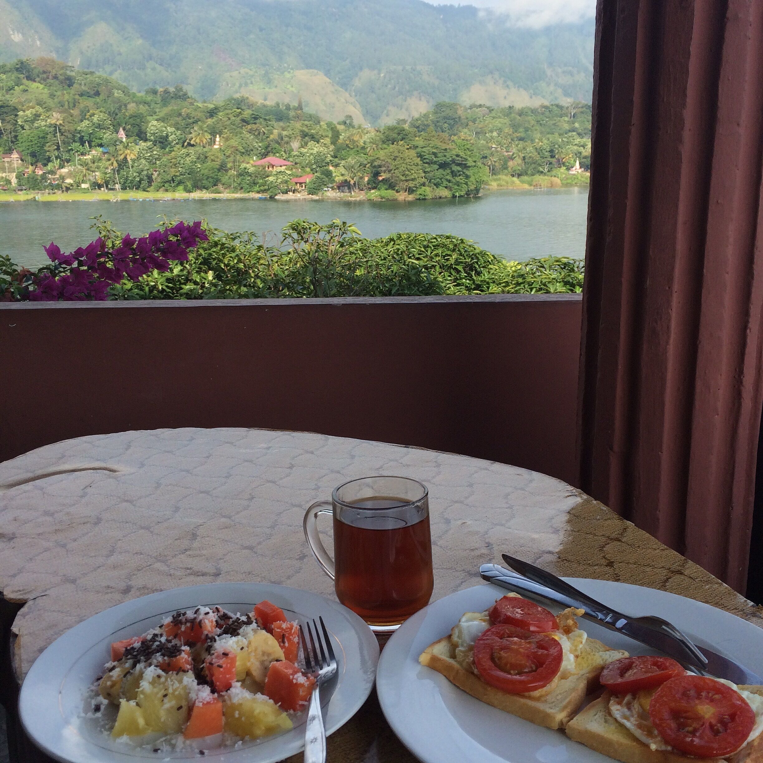 Amazing breakfast views and the tastiest fried egg and tomato on toast. I don't know what they do but it's perfect. American breakfast only 40,000IDR includes fruit salad and a hot drink. The restaurant has 270 degree views of beautiful Lake Toba.
