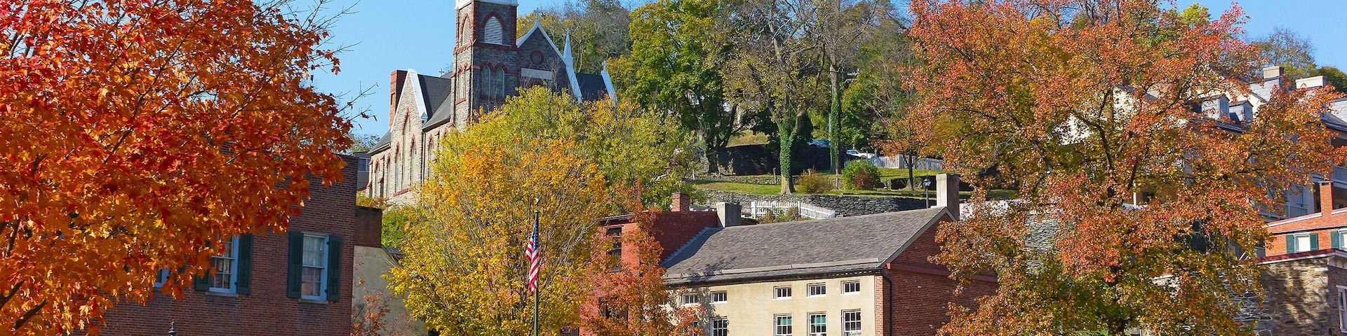Harpers Ferry historic town in autumn, West Virginia, USA. St. Peter's Catholic Church and historic town buildings.