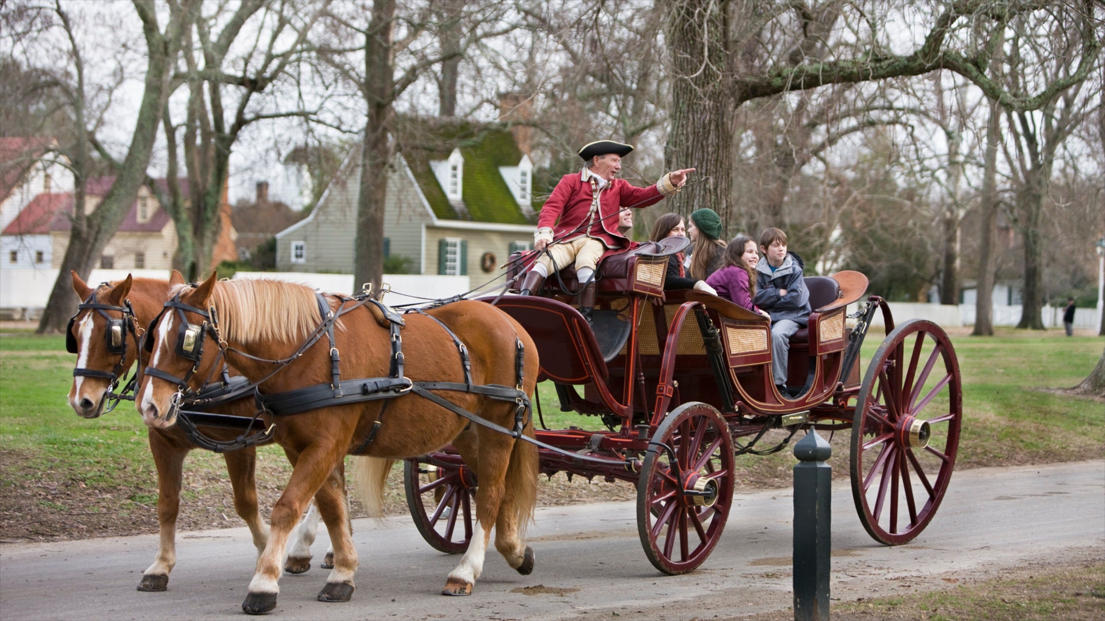 A horse-drawn carriage with passengers in historical attire.