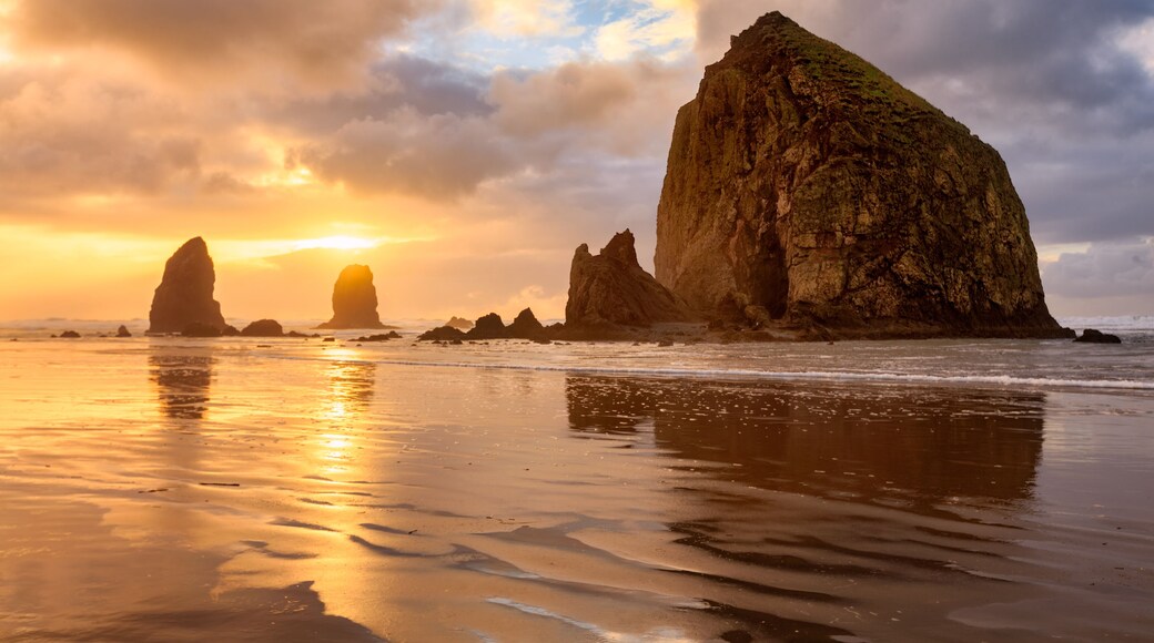 The sun sets behind Haystack Rock off the Oregon Coast