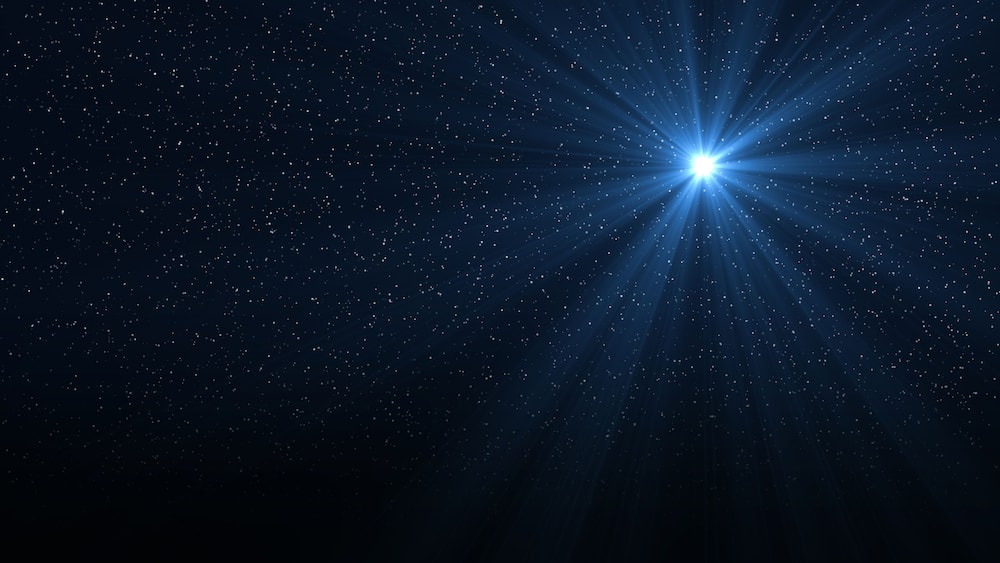 Christmas star of the Nativity of Bethlehem, Nativity of Jesus Christ. Background of the beautiful dark blue starry sky and bright star.