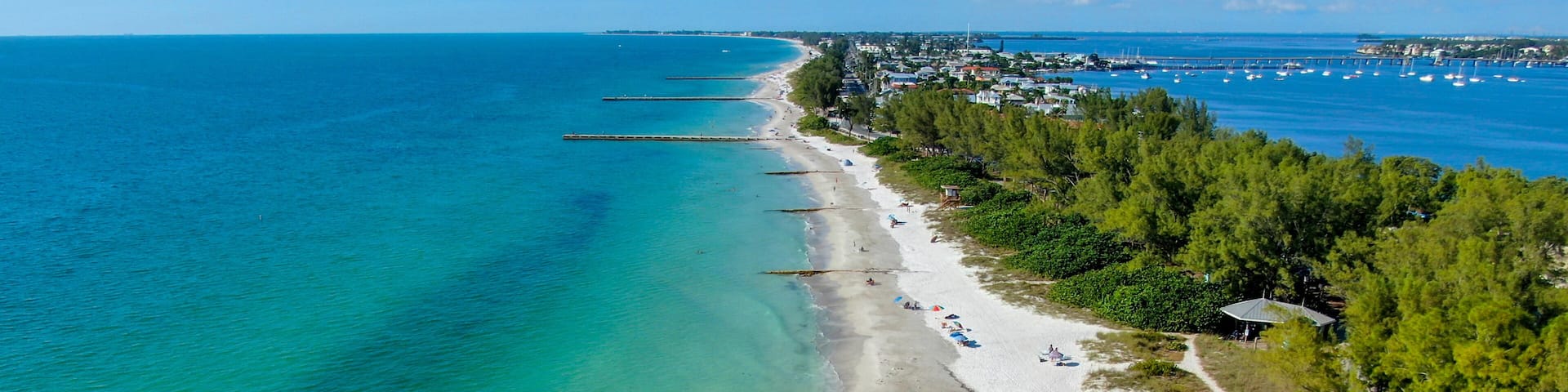 Aerial view of Coquina Beach white sand beach and turquoise water in Bradenton Beach during blue summer day, Anna Maria Island, Florida. USA