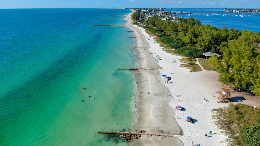 Aerial view of Coquina Beach white sand beach and turquoise water in Bradenton Beach during blue summer day, Anna Maria Island, Florida. USA
