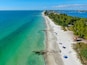 Aerial view of Coquina Beach white sand beach and turquoise water in Bradenton Beach during blue summer day, Anna Maria Island, Florida. USA