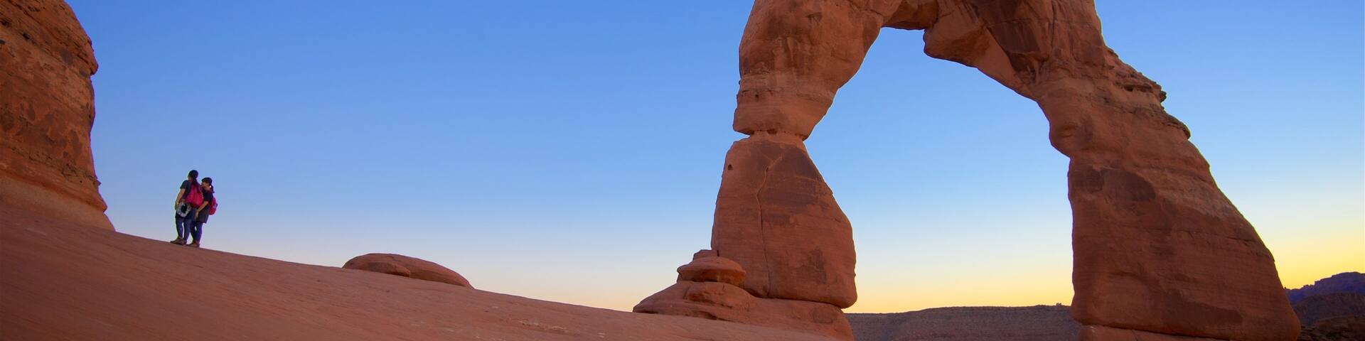 Delicate Arch featuring a sunset, landscape views and tranquil scenes