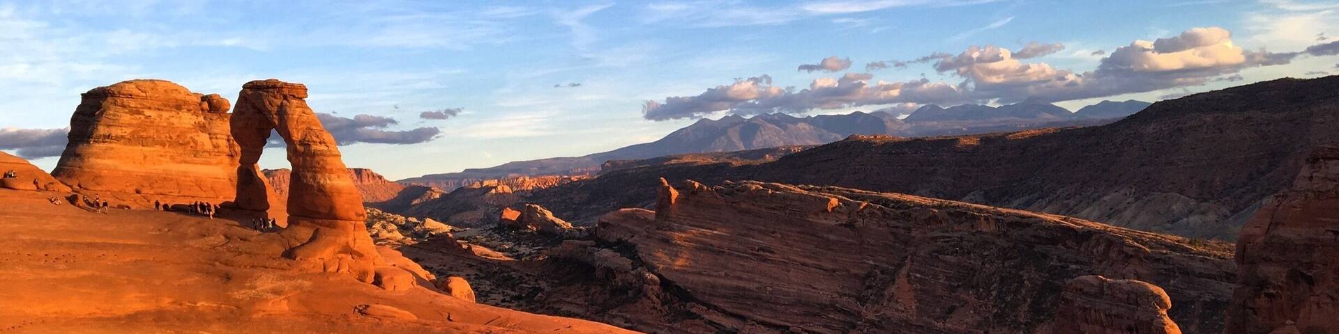 A desert landscape with prominent rock formations and a clear sky.