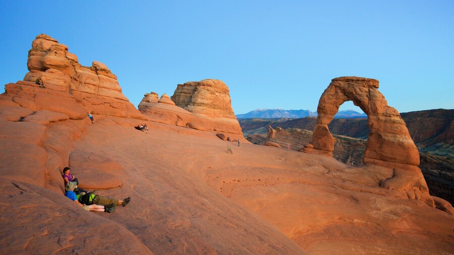 Delicate Arch featuring a sunset, tranquil scenes and a gorge or canyon