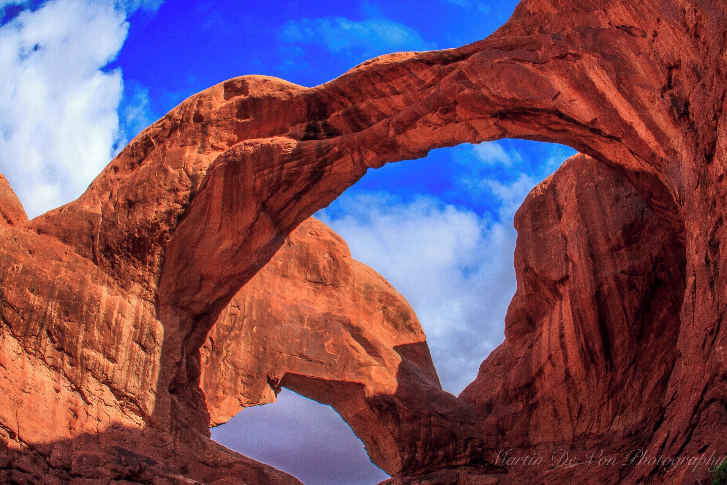 One of my favorite parks, and this is my favorite place in that park. 

Double Arch is a close-set pair of natural arches, one of the more known features of Arches National Park in Utah, United States. From the Double Arch parking area it's a 0.5 mile (0.8 km) round trip to the arches.[1] There are no guardrails or fences to prevent visitors from exploring directly beneath and through the arches.

The area was used as a backdrop for the opening scene of Indiana Jones and the Last Crusade, in which the arches are briefly visible. However, the cave shown in the movie does not exist.