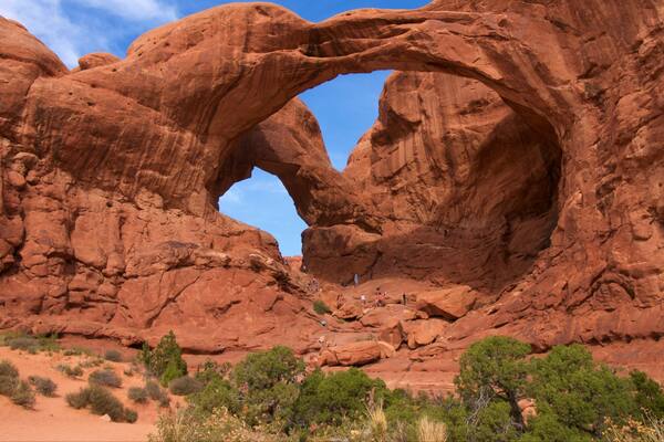 Double Arch showing hiking or walking, mountains and tranquil scenes