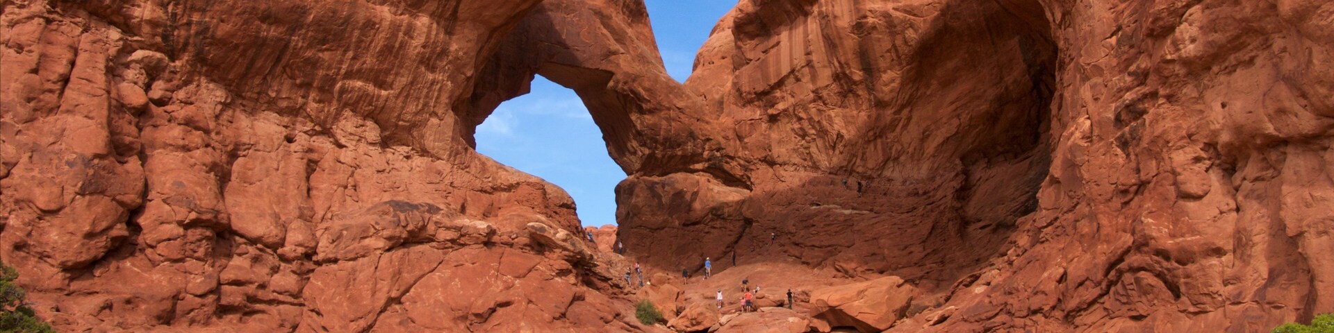 Double Arch showing hiking or walking, mountains and tranquil scenes