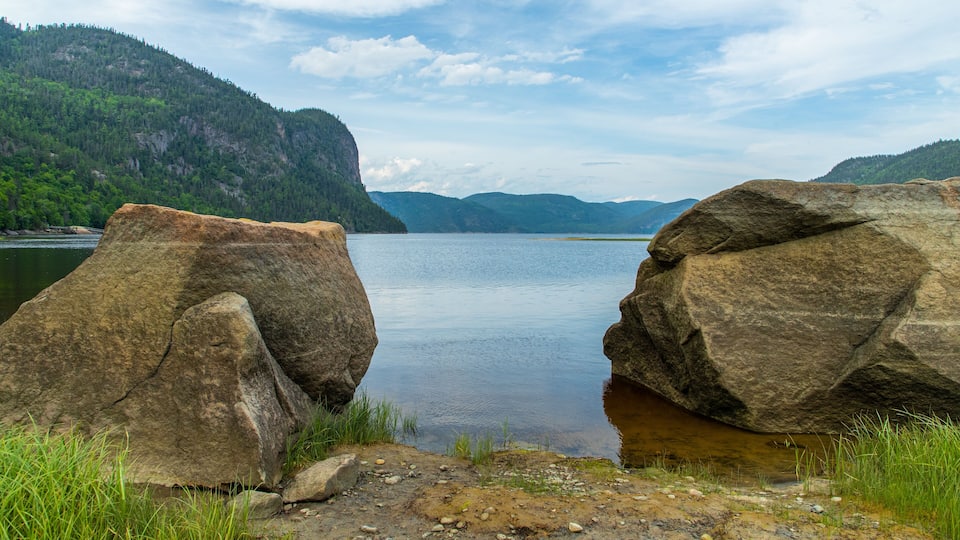 A lake surrounded by large rocks and mountains.