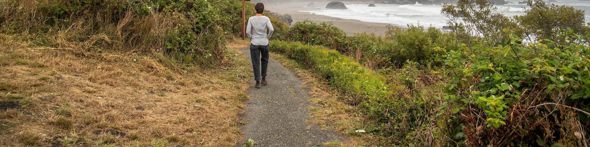 Lone Ranch Beach featuring general coastal views and rocky coastline as well as an individual femail