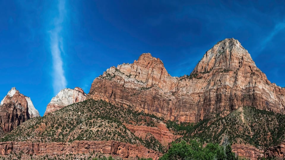 A mountain range with prominent peaks and a clear blue sky.