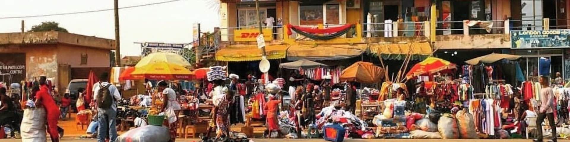 A bustling street market with various stalls and people.