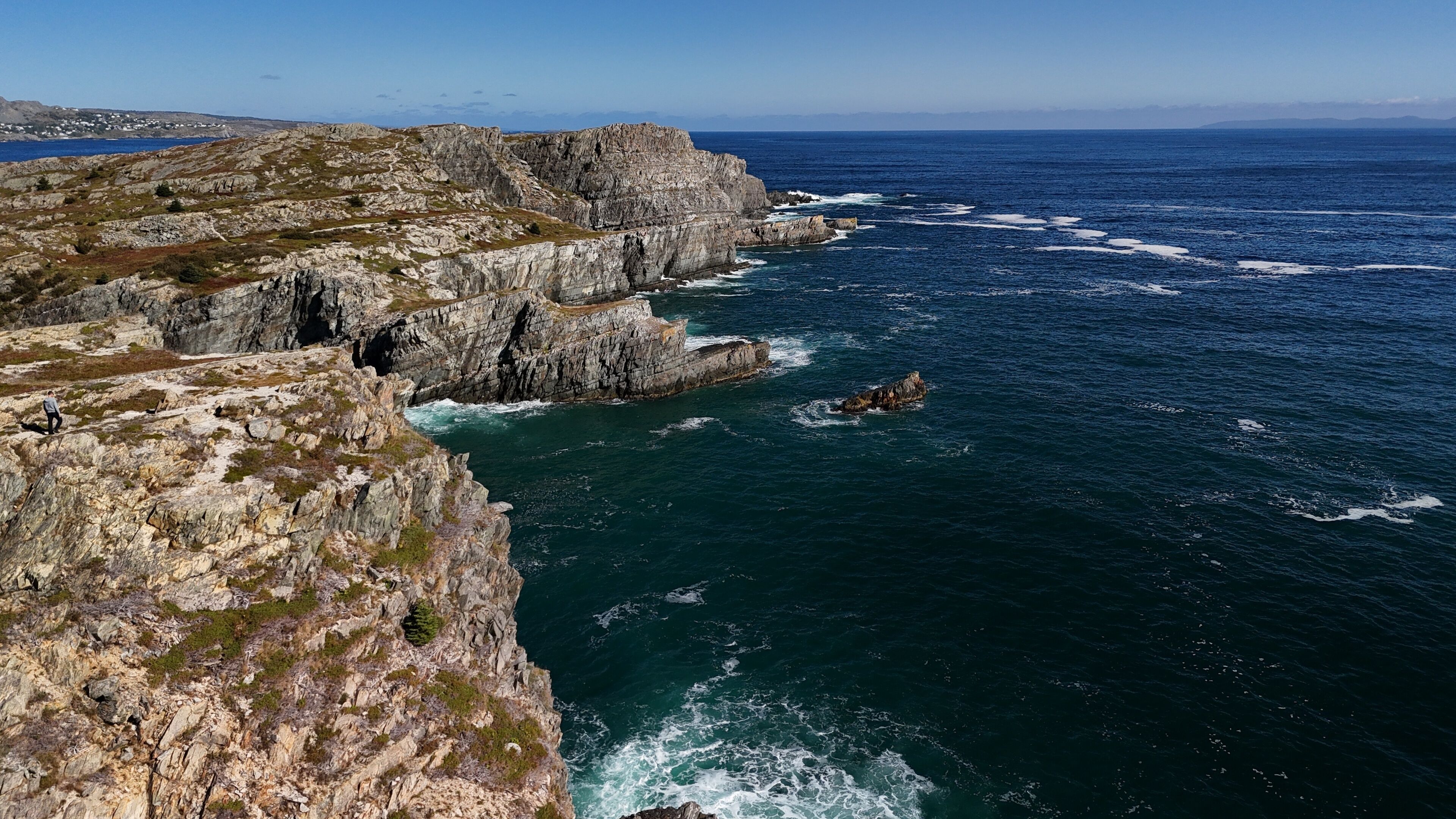 A rugged coastline with steep cliffs and a rocky shoreline.