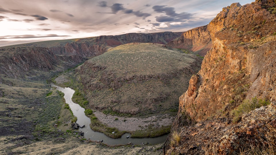 A canyon with a river winding through it.