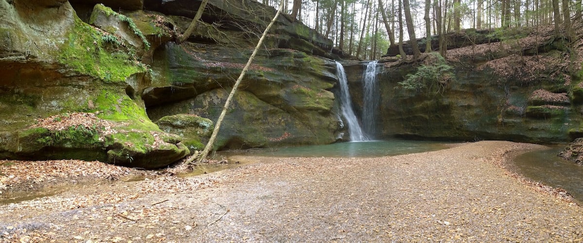 The highlight of the hike has to be the waterfalls at the end of the box canyon.
Rock Stalls Natural Sanctuary is a 70 acre private preserve in the Hocking Hills area that is owned and operated by Camp Akita, but the management of Camp Akita also allows access to the general public.
The sanctuary is definitely off the beaten path in the sometimes tourist heavy hocking hills area. It offers a quiet bit of respite with beautiful scenery in a box canyon with a creek and waterfalls.