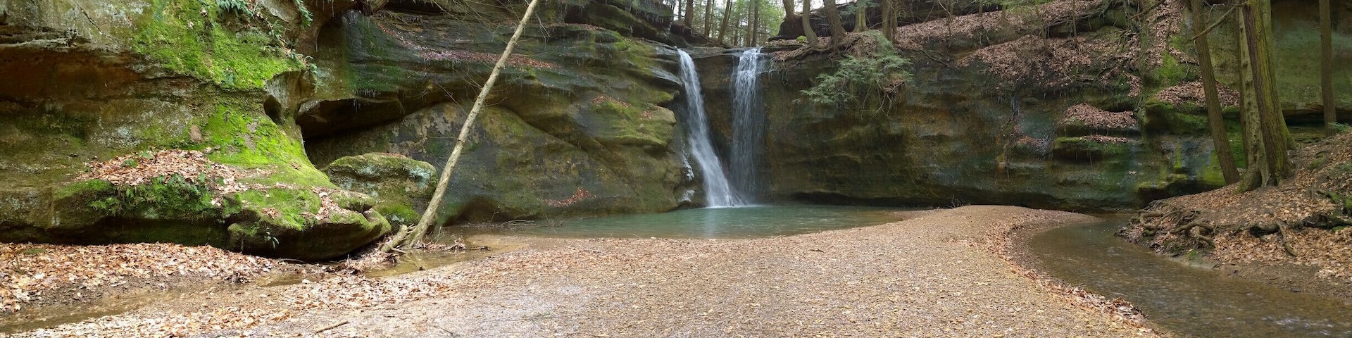 The highlight of the hike has to be the waterfalls at the end of the box canyon.
Rock Stalls Natural Sanctuary is a 70 acre private preserve in the Hocking Hills area that is owned and operated by Camp Akita, but the management of Camp Akita also allows access to the general public.
The sanctuary is definitely off the beaten path in the sometimes tourist heavy hocking hills area. It offers a quiet bit of respite with beautiful scenery in a box canyon with a creek and waterfalls.