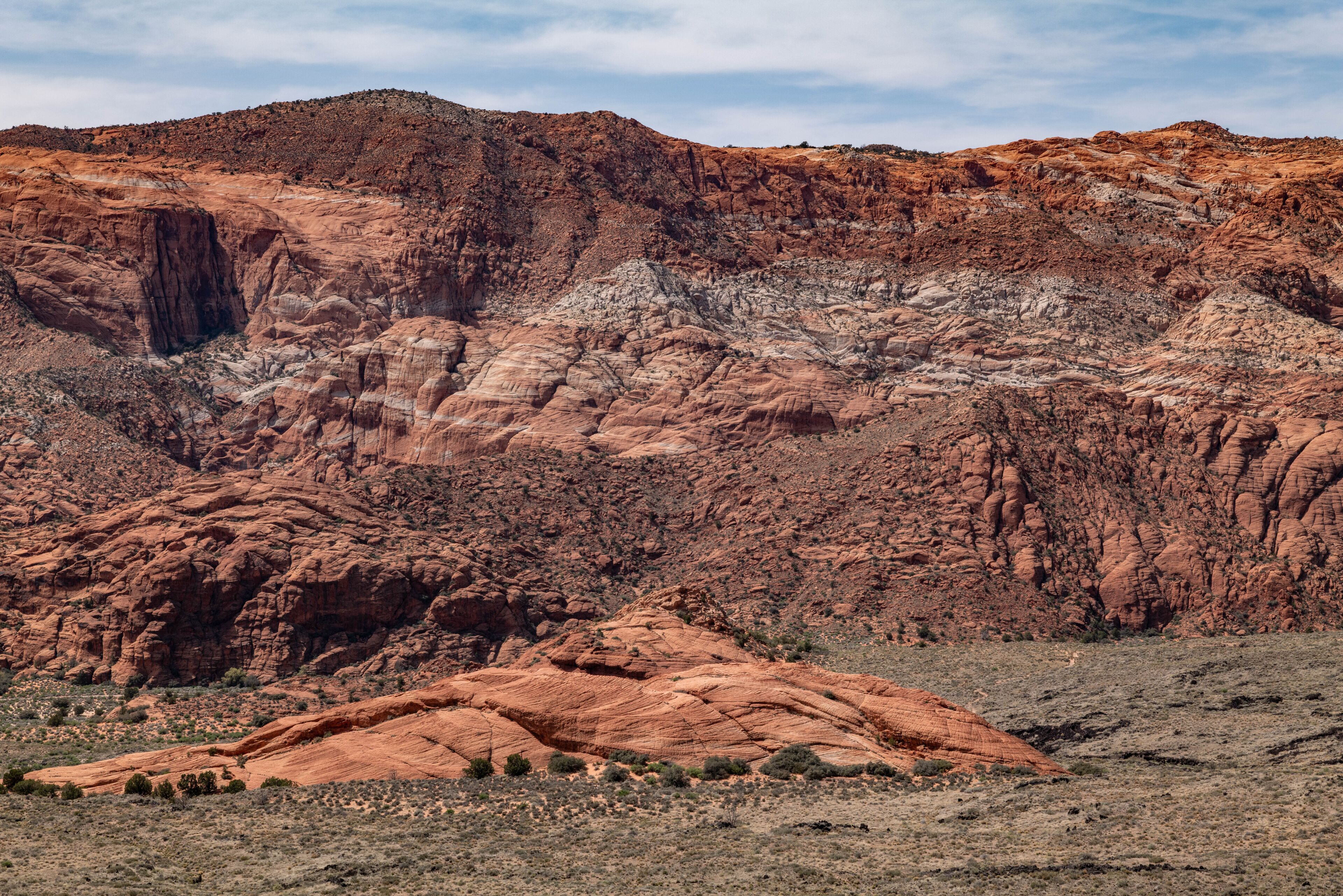 Santa Clara lava flow / basalt (Qbs) with Navajo Sandstone (Lower Jurassic), Snow Canyon Scenic Overlook, Snow Canyon State Park, Utah geology. Red Cliffs National Conservation Area
