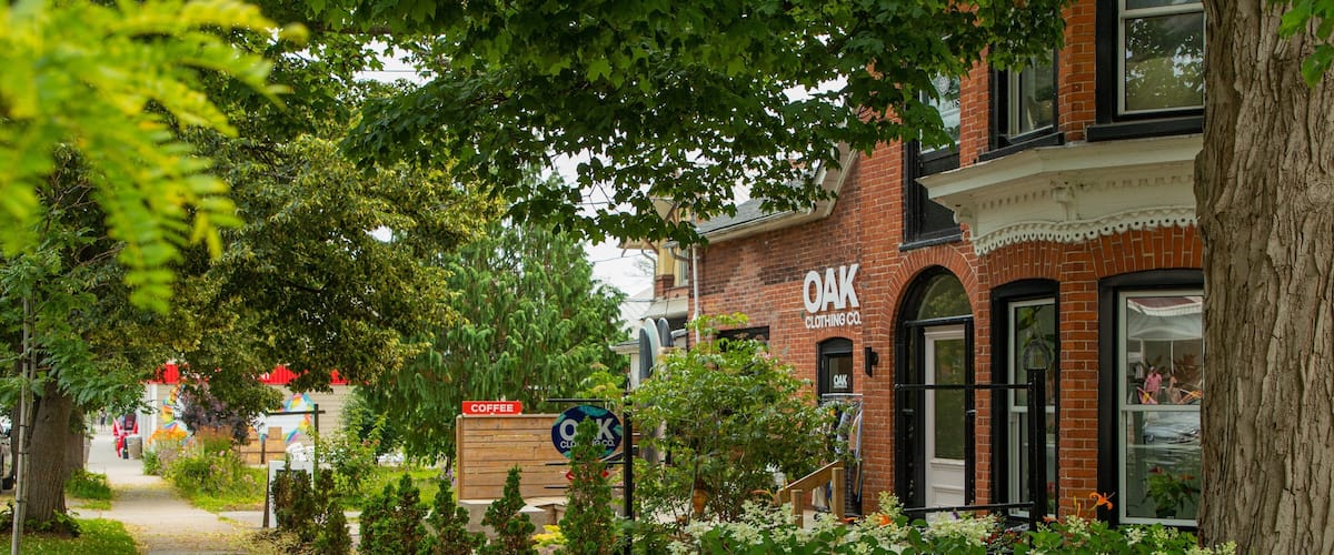 A brick building with a sign reading "Oak Clothing Co." and a sign for "Coffee."
