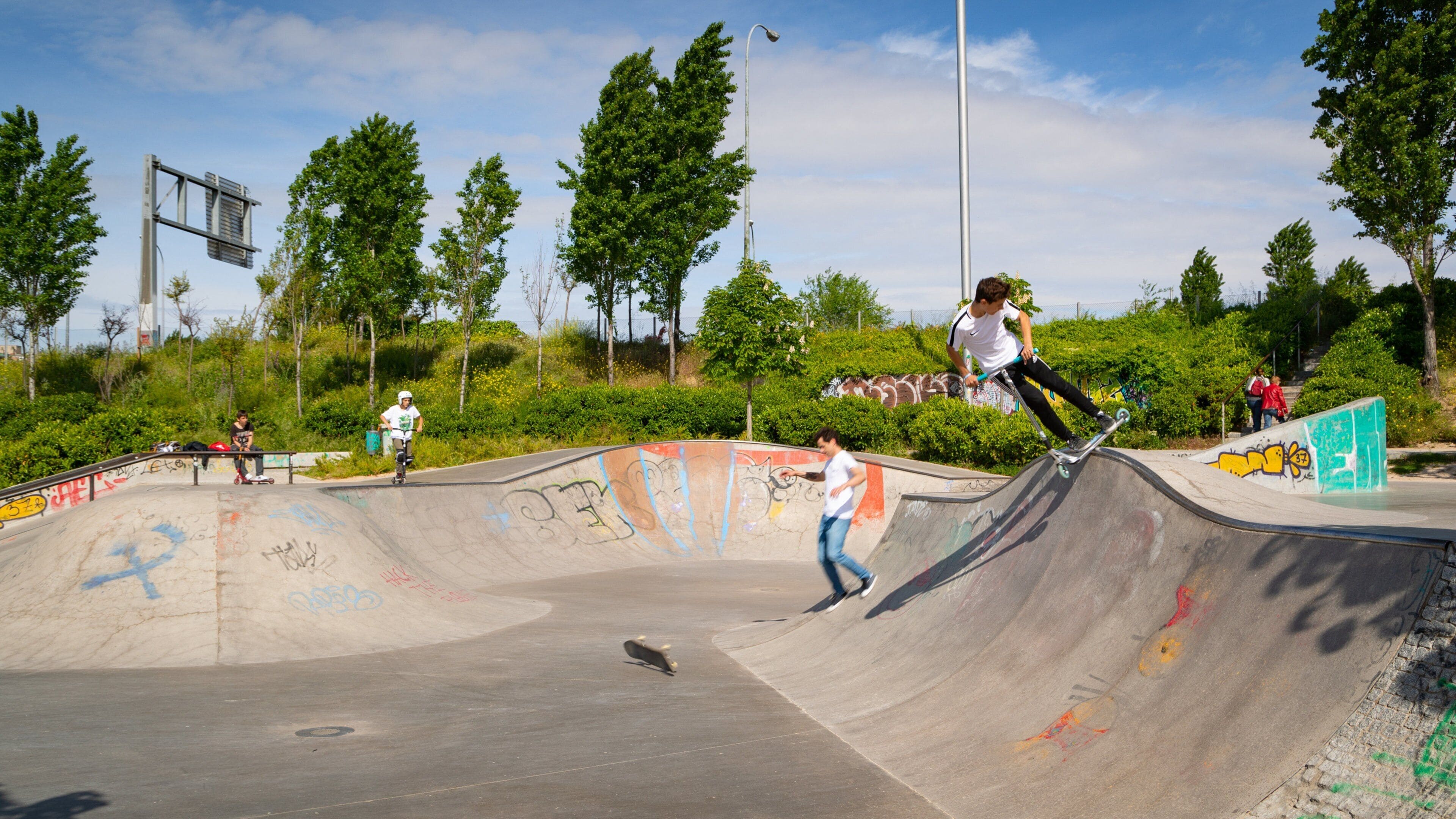 Madrid Rio which includes a garden as well as a small group of people