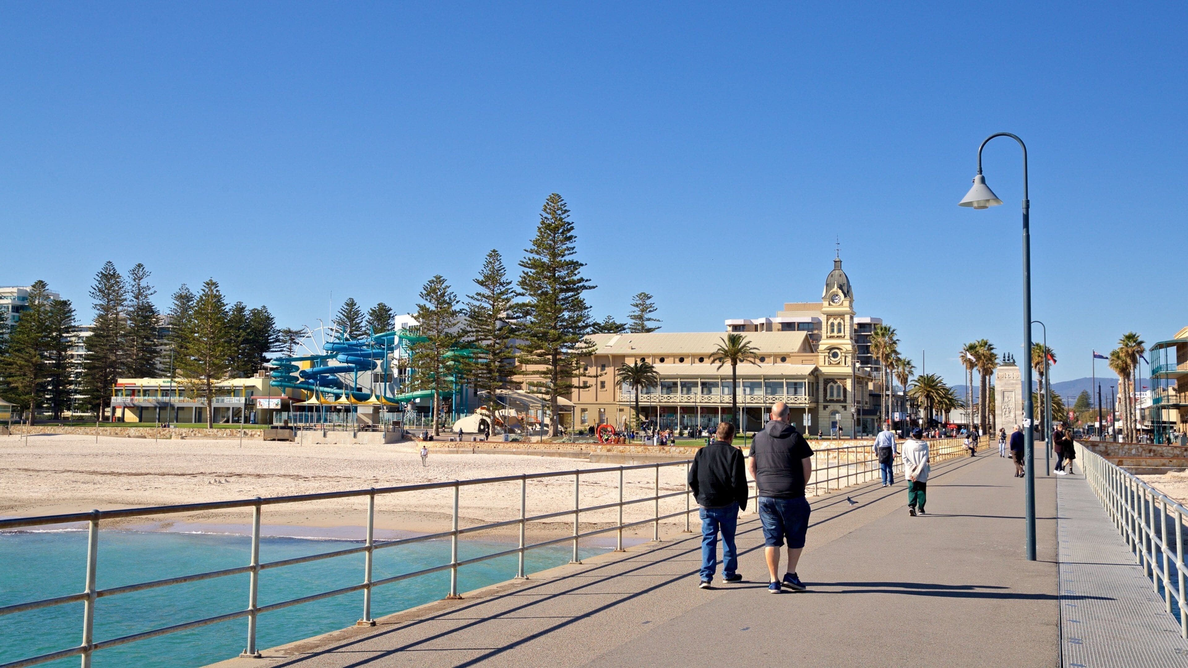Glenelg Jetty which includes a beach and general coastal views as well as a couple