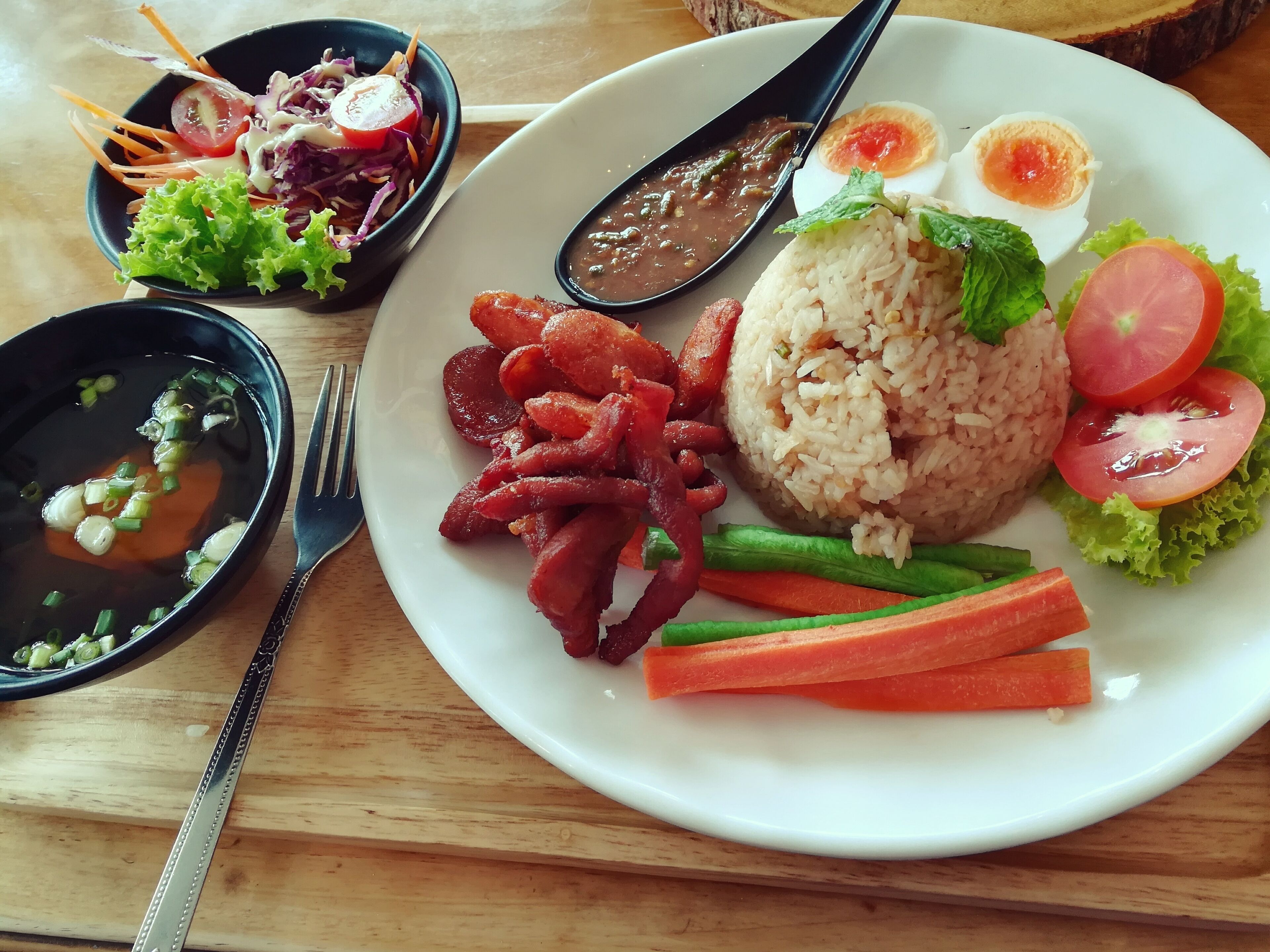 A shrimp paste sauce, called  Nam Prik Kapi, is one of the most popular dish in Thailand, usually served with vegetables. This is a shrimp paste chili fried rice served with soup, boiled eggs, fried Chinese sausage and fried pork. I like the taste and the decoration of the restaurant. #GoodEats