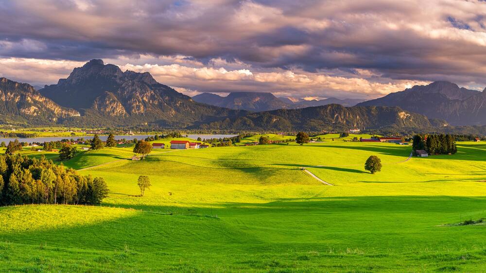 beautiful rural landscape in Bavaria with mountain range and meadow at springtime