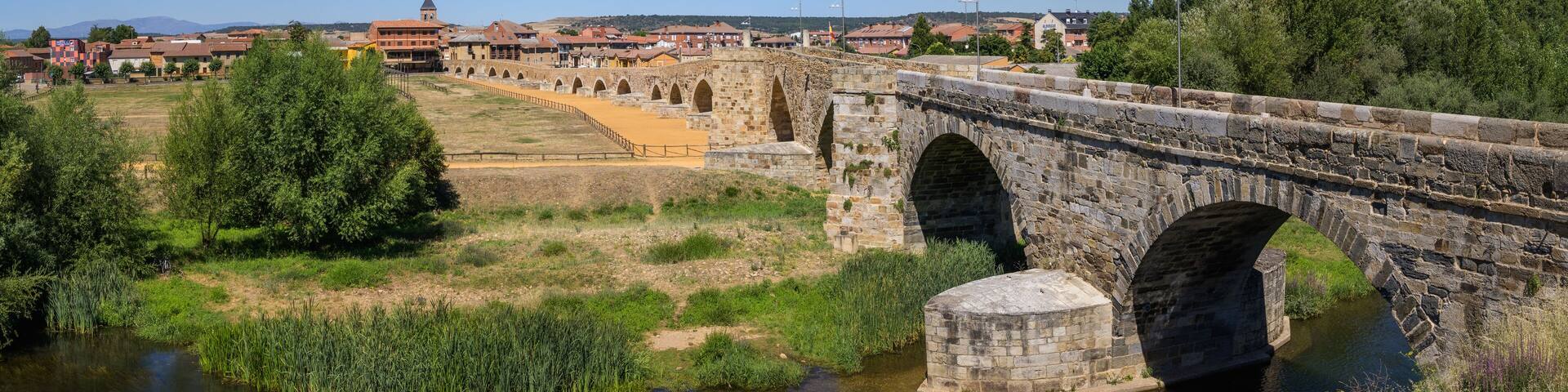 Summer's Awakening: Unveiling the Roman Bridge along the Camino de Santiago in Hospital de Orbigo, Leon, Spain